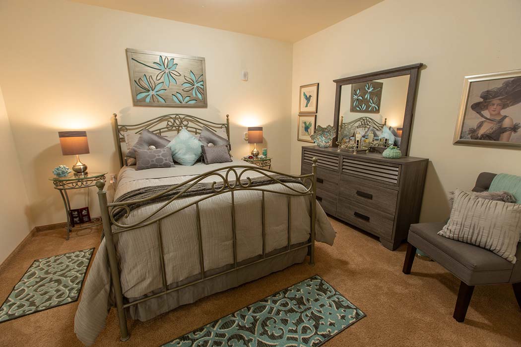 A furnished bedroom in a Ashton Gardens apartment